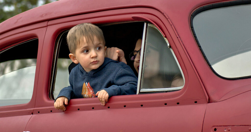 baby in red car