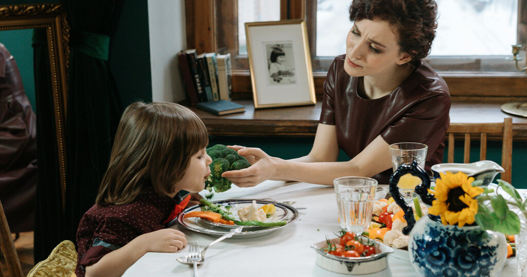 child and mom eating