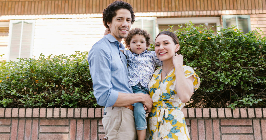 Sweet couple taking photo with baby