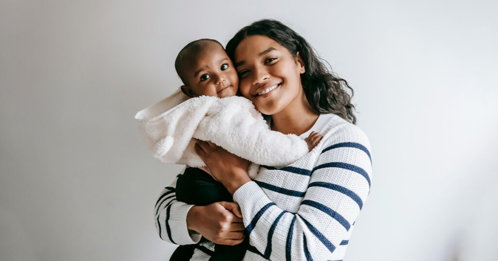 Smiling Mother and Baby Looking at Camera