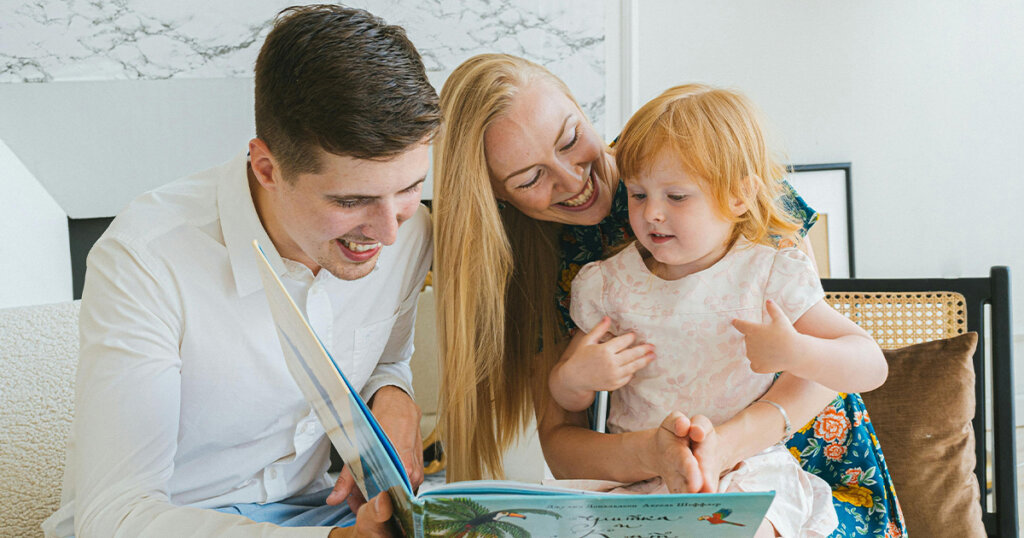 Photo of a Family Reading a Book Together