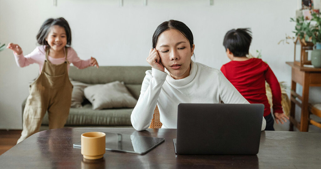 Kids making noise and disturbing mom working at home