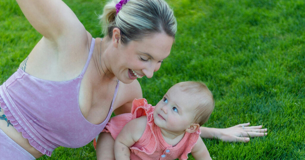 Photograph of a Baby Near Her Smiling Mother