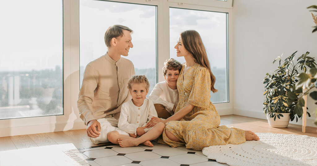 Couple watching each other with love while babies looking at camera