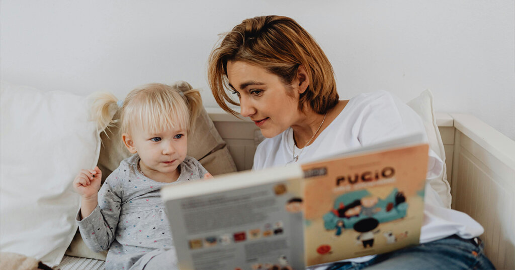 child and mom with book