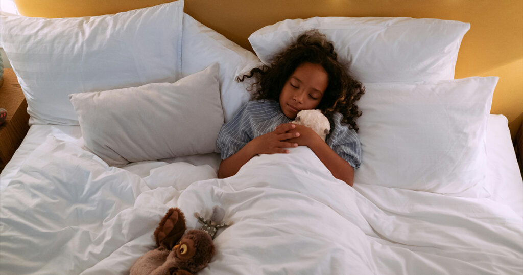 Girl Hugging a Stuff Toy While Sleeping