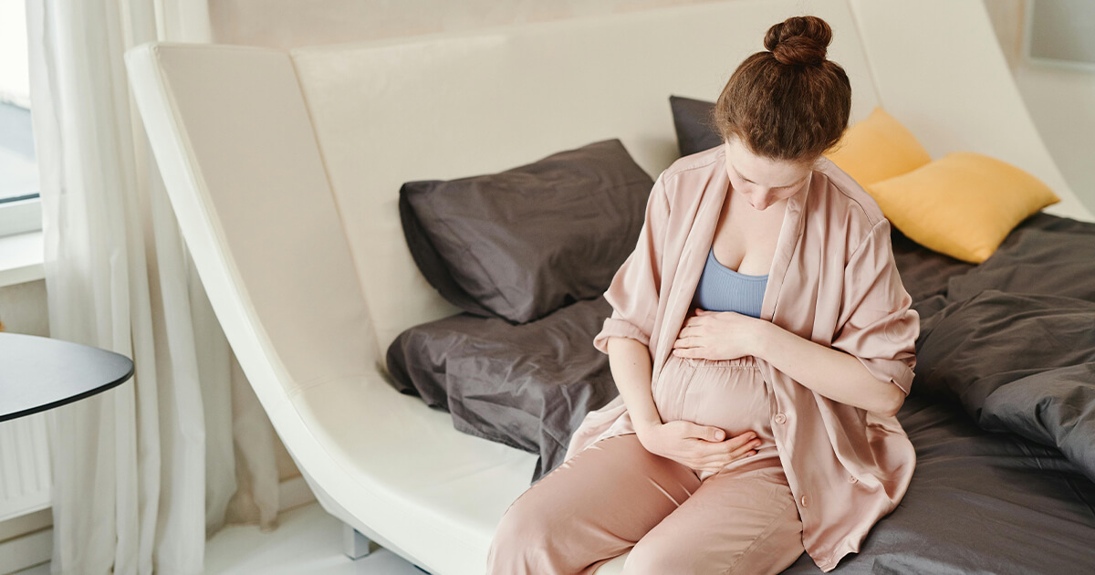 A Pregnant Woman holding her Belly