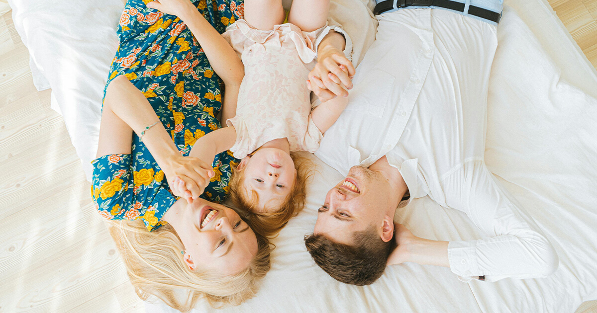 Overhead Shot of a Family Lying on the Bed