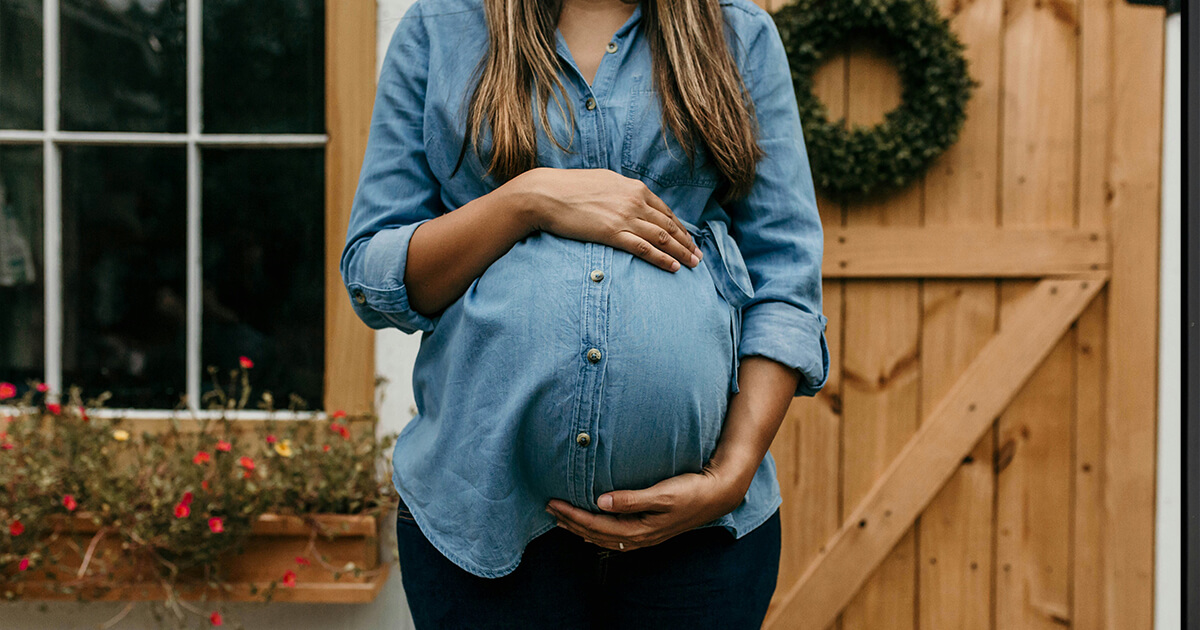 pregnant woman standing outside the door