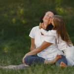 woman realizing her with little daughter in white dress