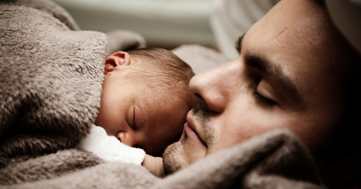 Close up of a Dad and his Little Baby Sleeping Together