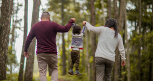 Man and Woman Carrying Toddler