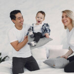 Man in White Crew Neck T-shirt Sitting Beside Woman in White T-shirt