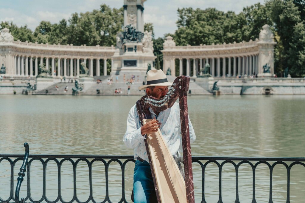 Man in White Dress Shirt Playing Harp