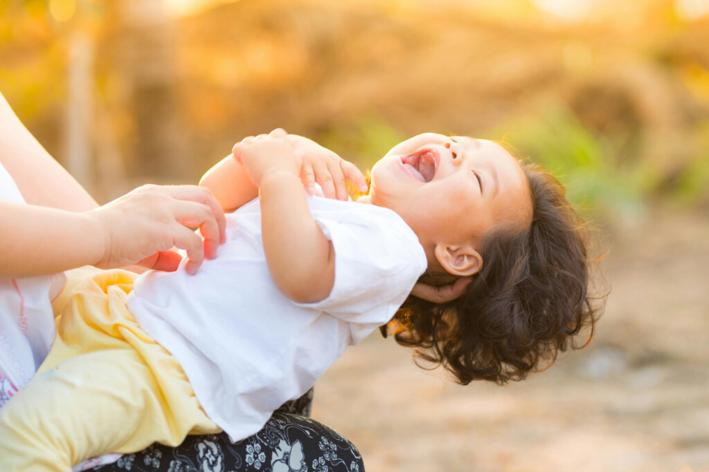 Person Carrying Child Wearing White Top