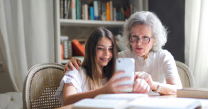 Photo of Woman Showing Her Cellphone to Her Grandmother