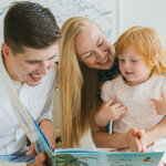 Photo of a Family Reading a Book Together