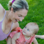 Photograph of a Baby Near Her Smiling Mother