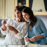 Woman In Blue Long Sleeve Shirt Beside Her Mother