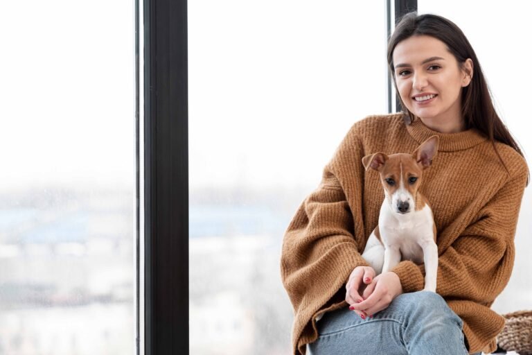 woman-posing-while-holding-dog-her-lap