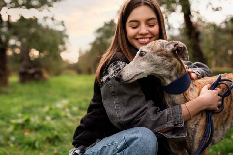 side-view-smiley-woman-hugging-dog