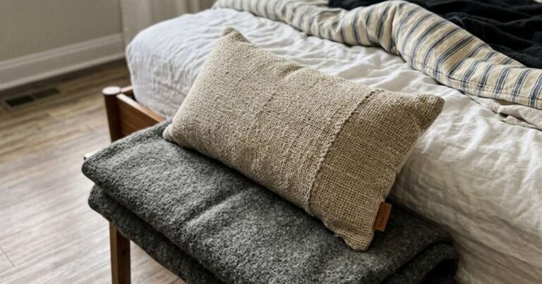 Pillow Reviews & Sleep Gear, Analyzed With Real Data 3 a-firm-textured-pillow-resting-on-a-folded-blanket-at-the-foot-of-a-bed-showcasing-best-pillows-for-neck-pain