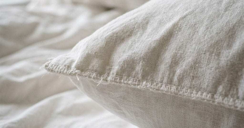 close up of a white cotton pillowcase corner showcasing