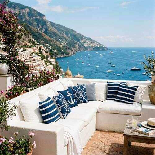 nautical blue pillows sunlit amalfi cliffs